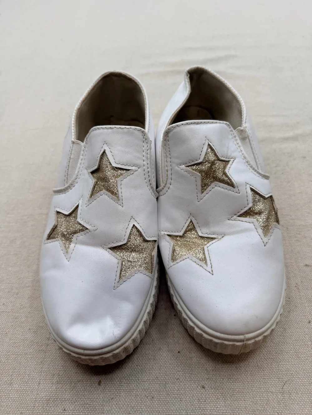 ' White Slip-On Sneakers with Gold Star Accents